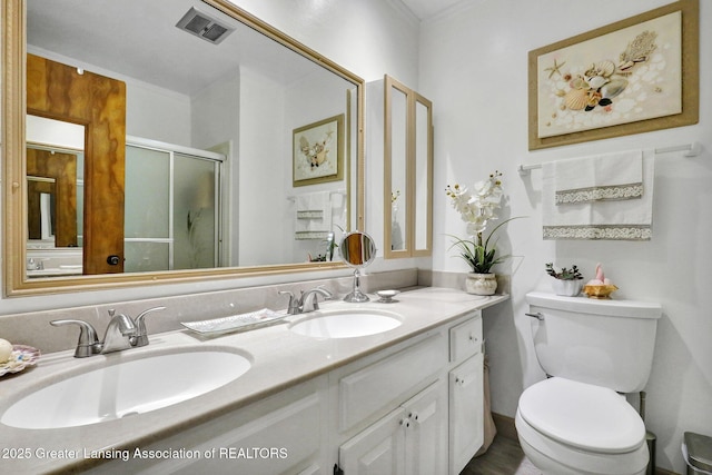 full bathroom featuring a shower stall, double vanity, visible vents, and a sink