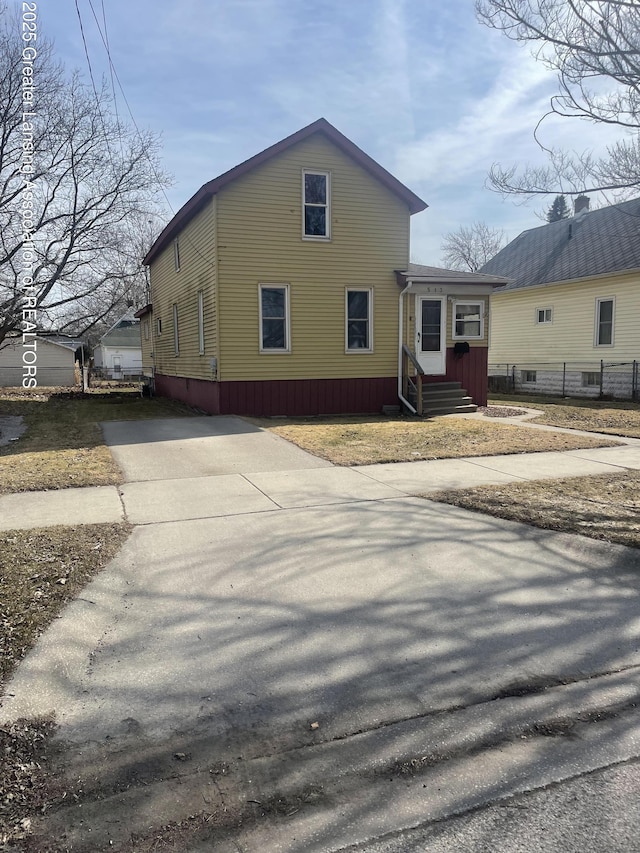 view of side of property with driveway and entry steps