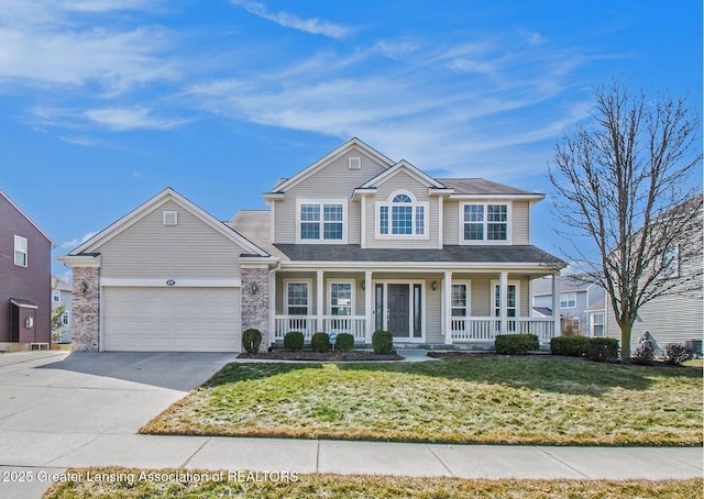 view of front of property with a porch, an attached garage, driveway, and a front yard