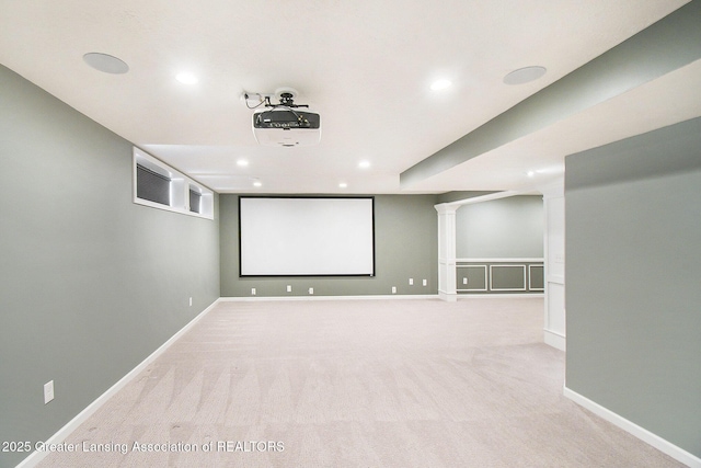 carpeted cinema room with recessed lighting and baseboards