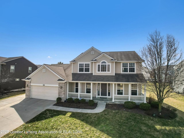 traditional home with concrete driveway, a garage, covered porch, and a front yard