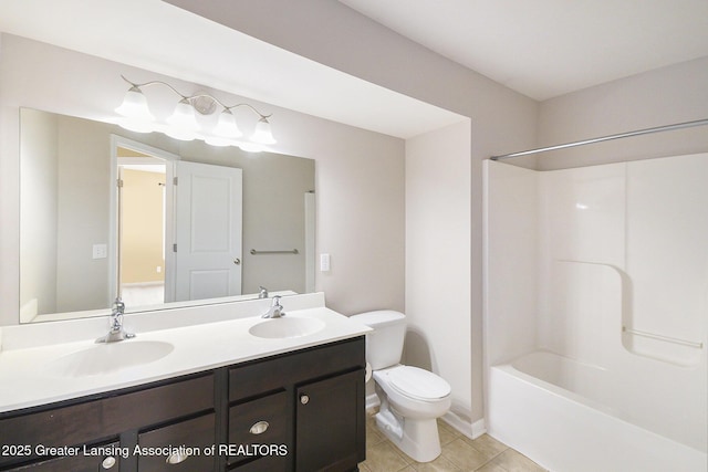 full bathroom with a sink, toilet, double vanity, and tile patterned floors