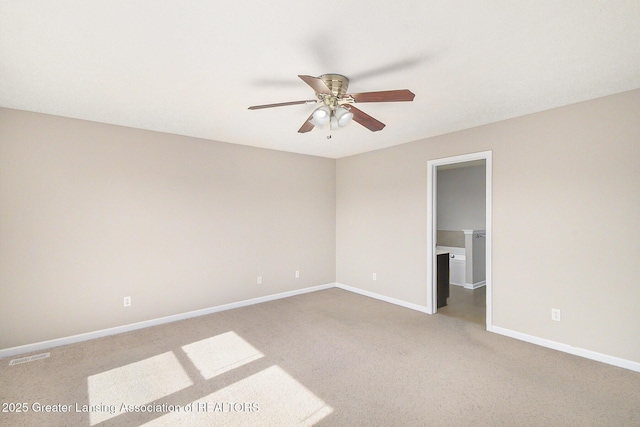 spare room featuring visible vents, baseboards, a ceiling fan, and carpet floors