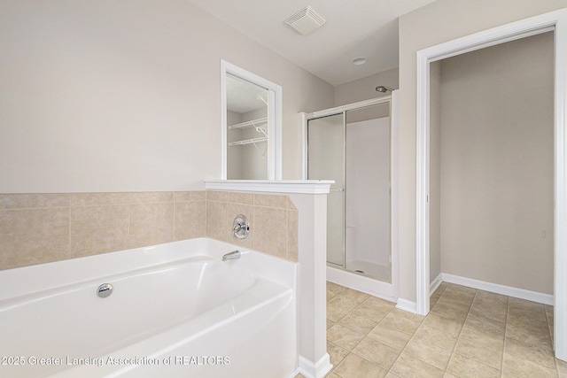 full bathroom featuring a bath, visible vents, a stall shower, and baseboards