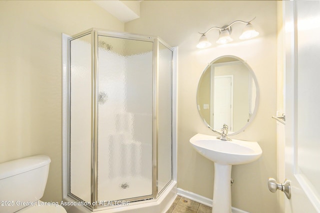 bathroom with toilet and a shower stall