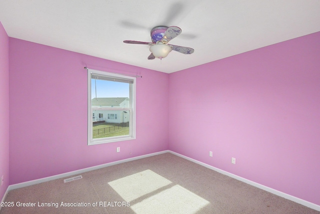 unfurnished room with visible vents, baseboards, carpet, and a ceiling fan