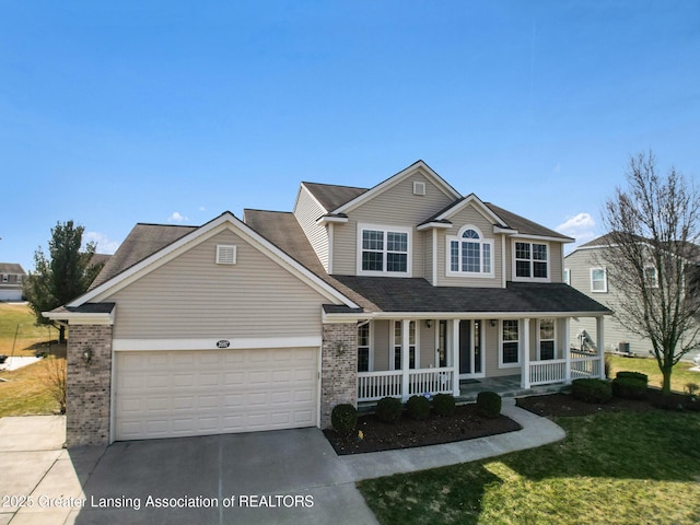 traditional-style house with a front lawn, driveway, a porch, a garage, and brick siding