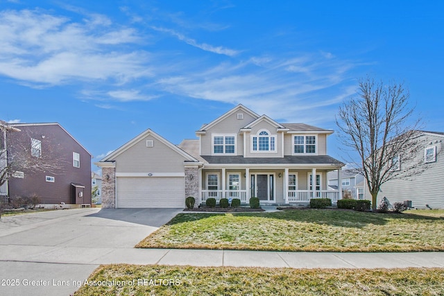 view of front of home featuring concrete driveway, a front yard, covered porch, stone siding, and an attached garage