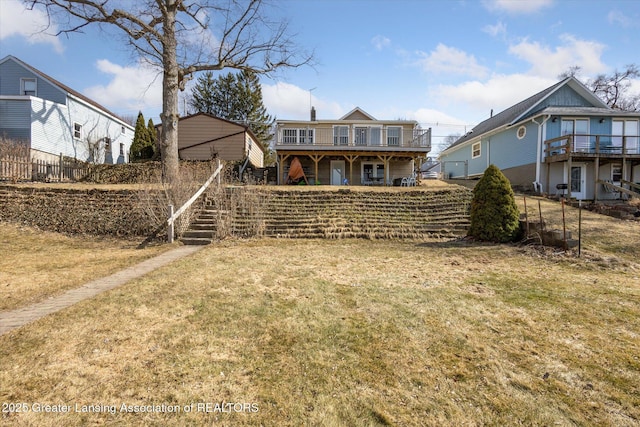 back of house with a wooden deck, stairs, and a yard