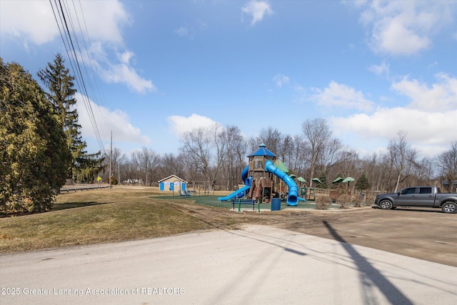 community jungle gym featuring a lawn