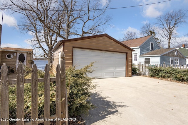 detached garage featuring fence