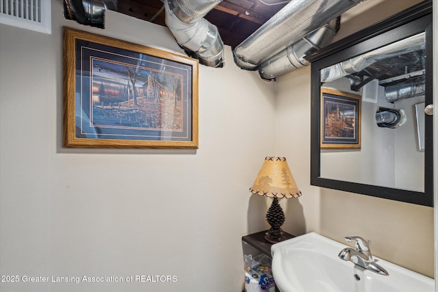 bathroom featuring visible vents and a sink