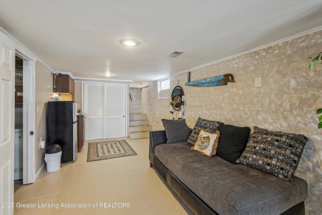 living room with stairs, crown molding, and visible vents