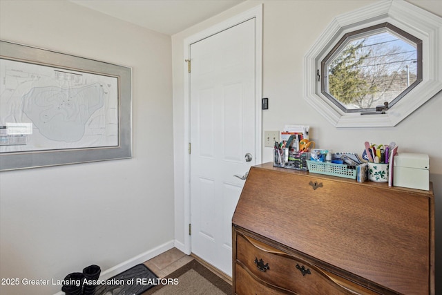 doorway to outside with baseboards