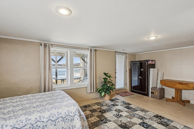 bedroom featuring concrete block wall and crown molding