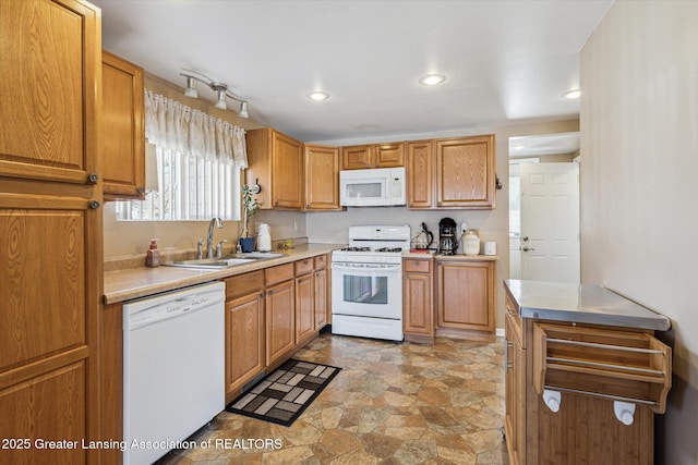 kitchen with white appliances, recessed lighting, a sink, light countertops, and stone finish flooring