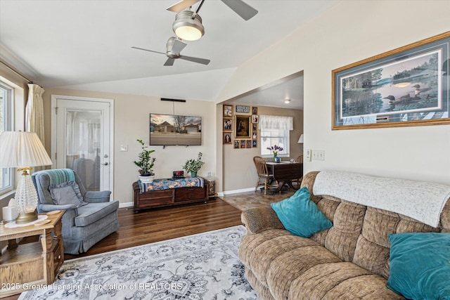 living room featuring baseboards, lofted ceiling, ceiling fan, and wood finished floors