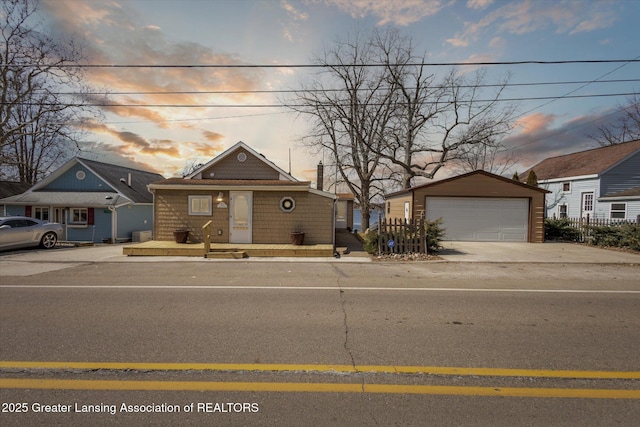 view of front of home featuring a detached garage and an outdoor structure