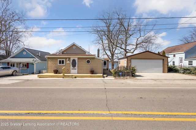 view of front of home featuring a garage and an outdoor structure