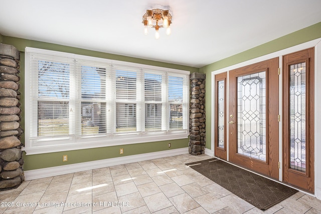 entryway featuring baseboards