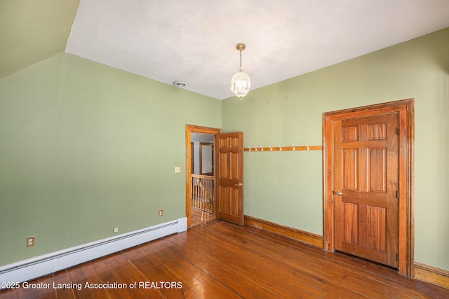spare room with hardwood / wood-style flooring, a baseboard heating unit, baseboards, a chandelier, and vaulted ceiling