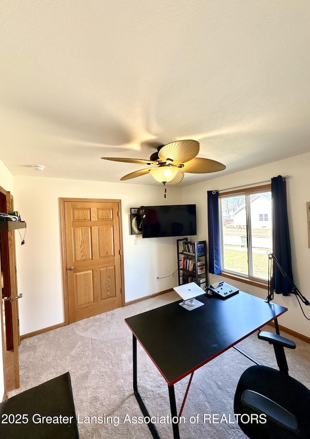 office space featuring a ceiling fan, baseboards, and carpet floors