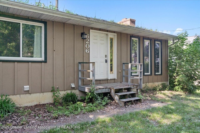 entrance to property featuring board and batten siding and a chimney