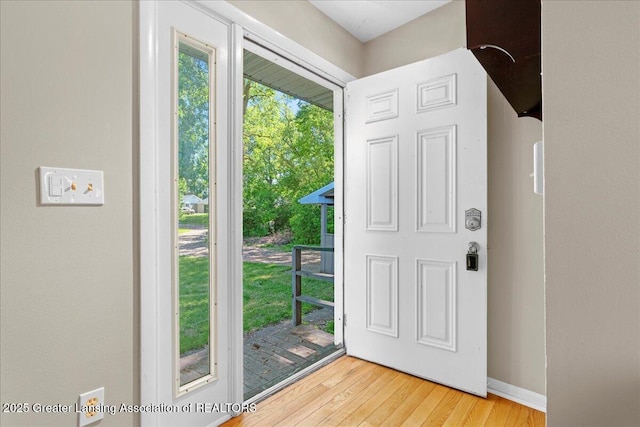 entrance foyer with baseboards and light wood-style flooring