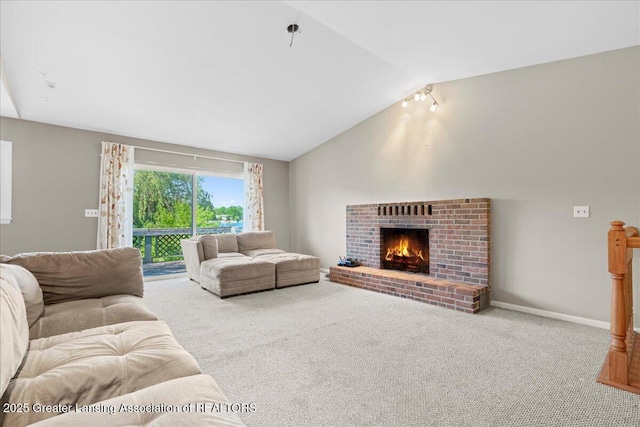 living area with carpet floors, a fireplace, baseboards, and vaulted ceiling