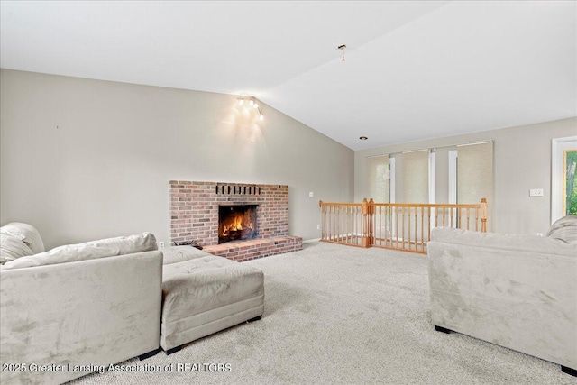 carpeted living area with lofted ceiling and a brick fireplace