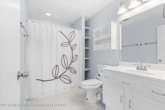 bathroom featuring a shower with shower curtain, toilet, vanity, and tile patterned floors