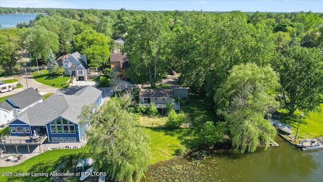 birds eye view of property featuring a view of trees, a water view, and a residential view