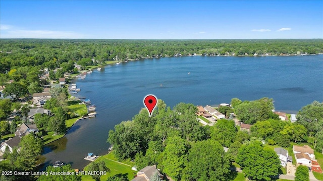 birds eye view of property featuring a forest view, a water view, and a residential view