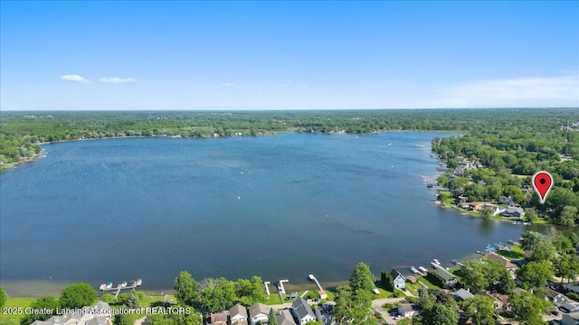 bird's eye view featuring a wooded view and a water view