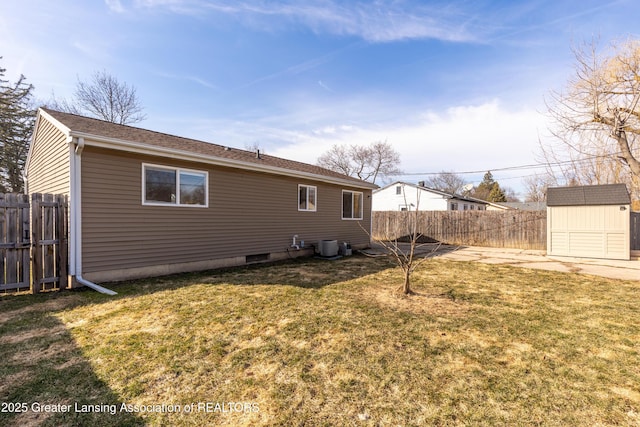 back of property featuring an outbuilding, central AC unit, a shed, a fenced backyard, and a lawn