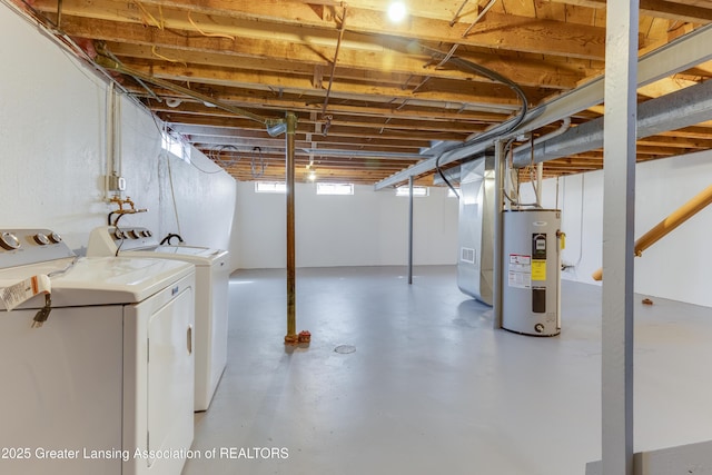 basement with washing machine and dryer and electric water heater