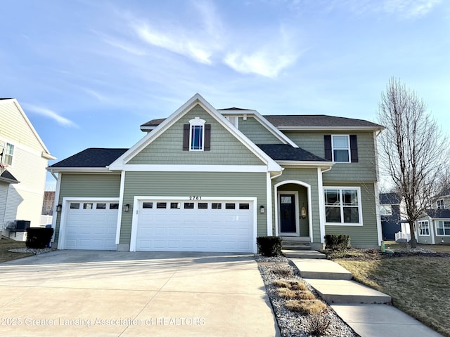 view of front of property with central AC unit, driveway, and a garage