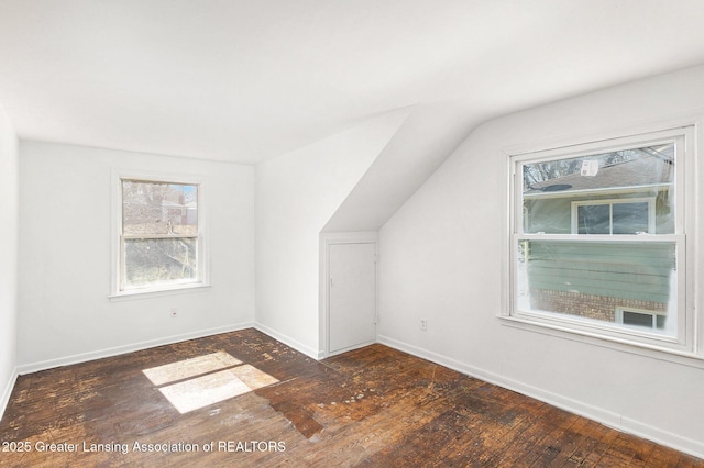 bonus room with vaulted ceiling, baseboards, and wood-type flooring