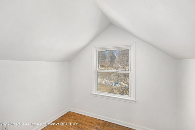 bonus room featuring vaulted ceiling, wood finished floors, and baseboards