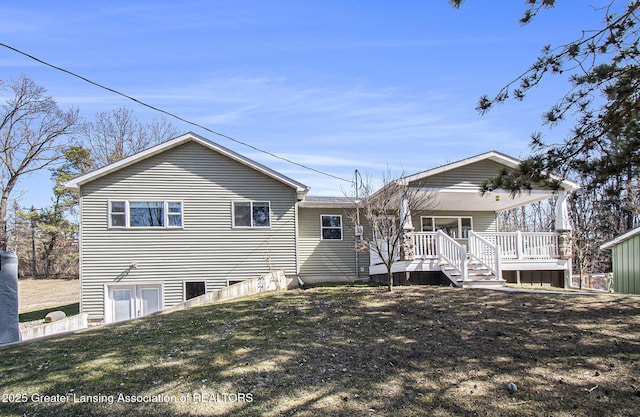 rear view of property with a lawn