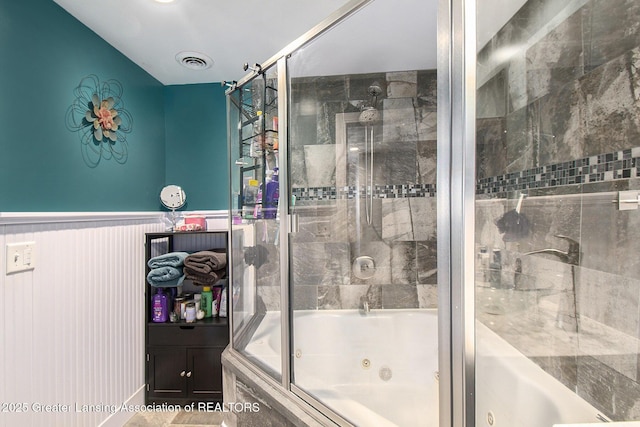 full bath featuring visible vents, a wainscoted wall, and a combined bath / shower with jetted tub