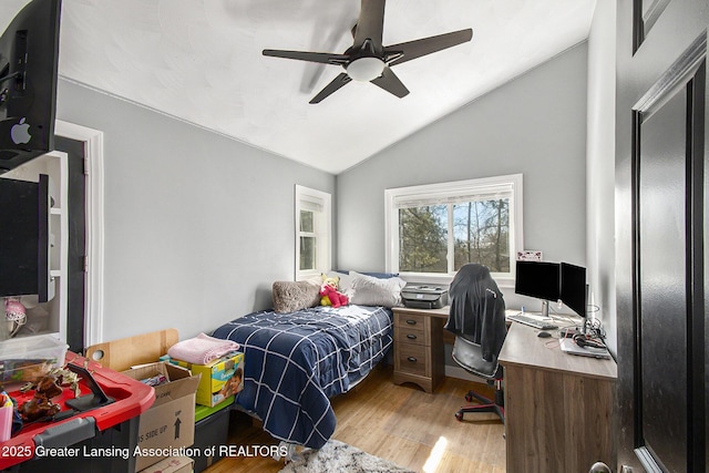 bedroom featuring lofted ceiling, light wood-style floors, and ceiling fan