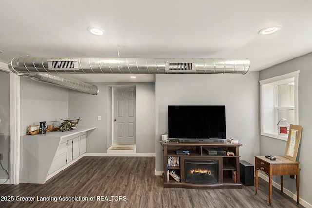 interior space featuring dark wood finished floors, baseboards, and visible vents