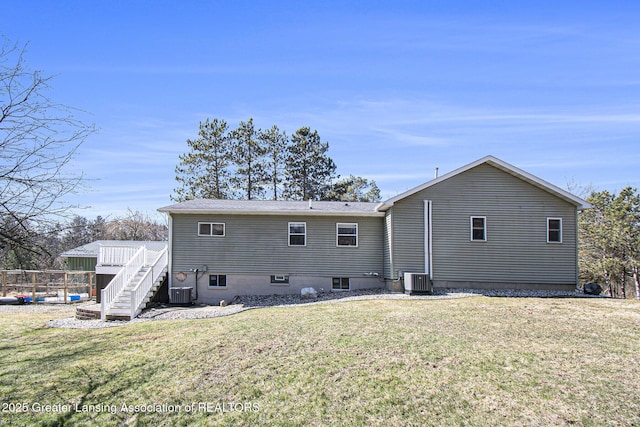 back of house with stairway, a yard, cooling unit, and a wooden deck