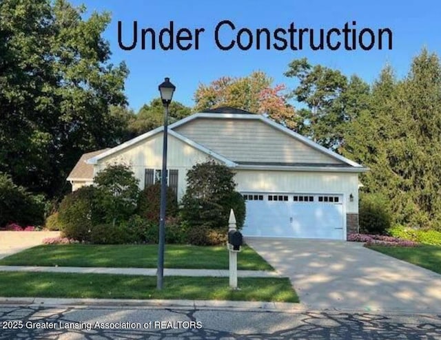 view of front of home with driveway, a front yard, and an attached garage