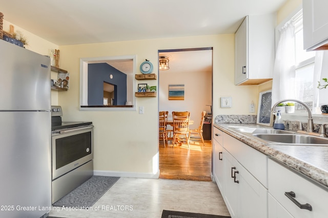 kitchen featuring a sink, light countertops, white cabinets, and stainless steel appliances