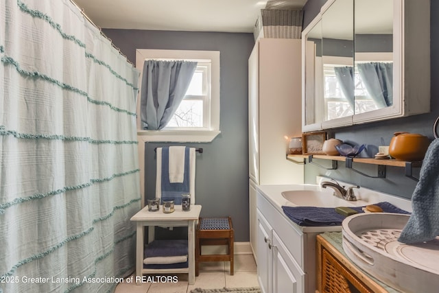 full bathroom with tile patterned floors, baseboards, a shower with shower curtain, and vanity