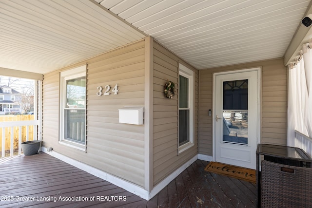 view of exterior entry featuring a porch