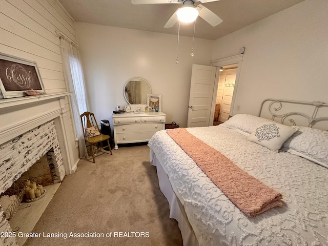 1793 N Shore Dr, Crystal, MI 48818 - bedroom featuring light carpet, a fireplace, and ceiling fan
