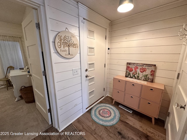 1793 N Shore Dr, Crystal, MI 48818 - corridor featuring dark wood-style flooring and wooden walls